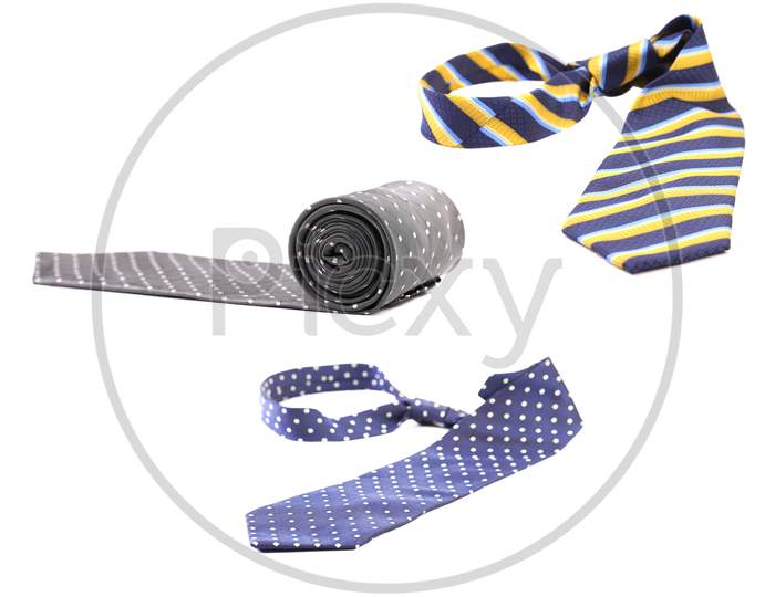 Three Multi-Colored Tie On A White Background