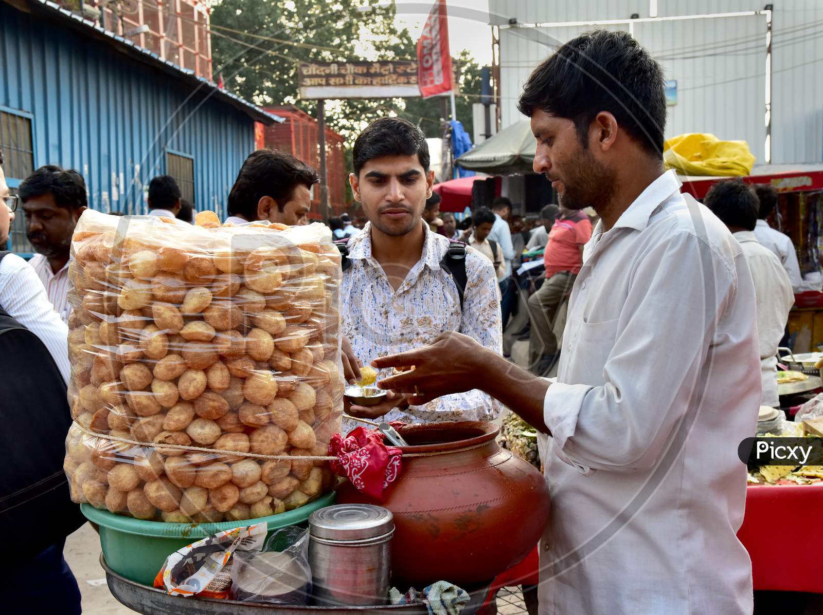 Indian Street Food Panipuri Or Golgappae Vendor Serving At a Road Side Street Food Stall