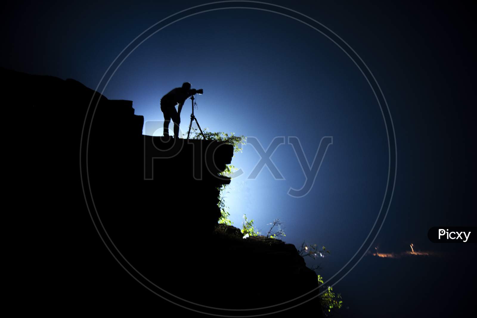 Silhouette Of a Photographer Over a Hill Cliff