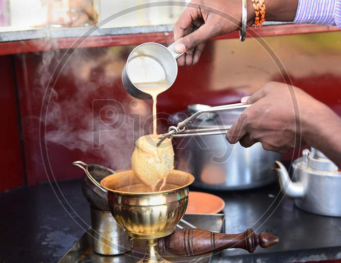 A Tea Vendor Making Tandoori Chai At a Tea Stall in Pune