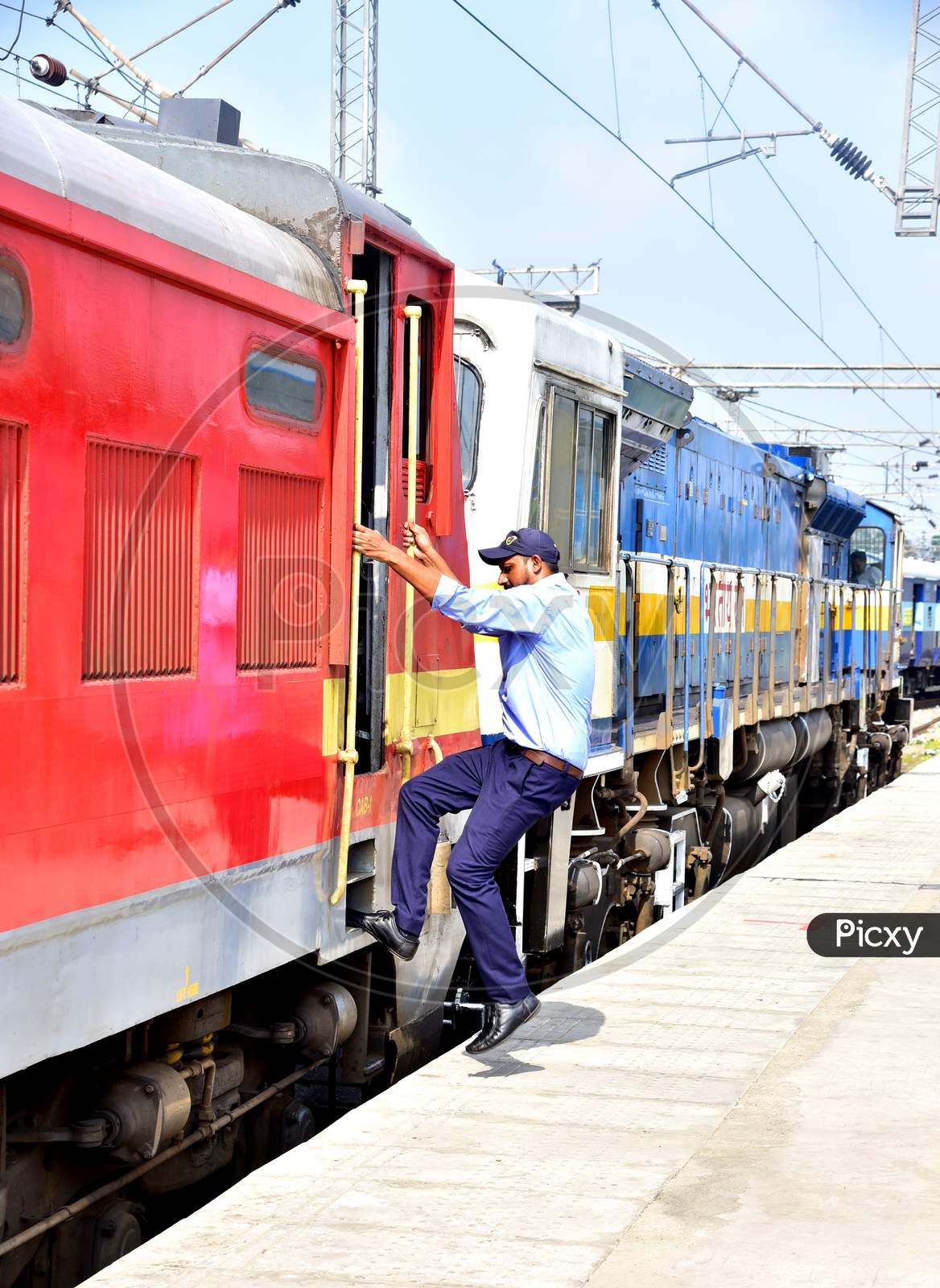 Image of A Man Boarding a Running Train From a Railway Station  Platform-FO982780-Picxy