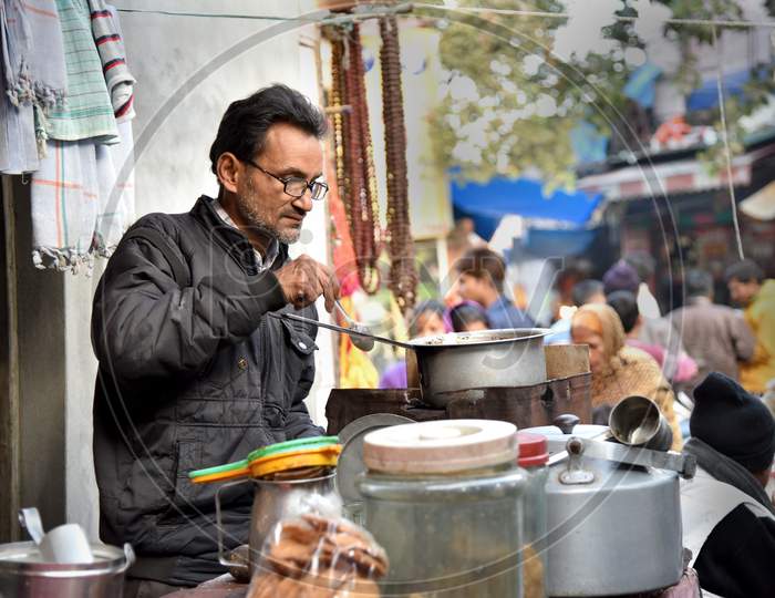 A Tea Vendor Making Tea At a Road Side Stall