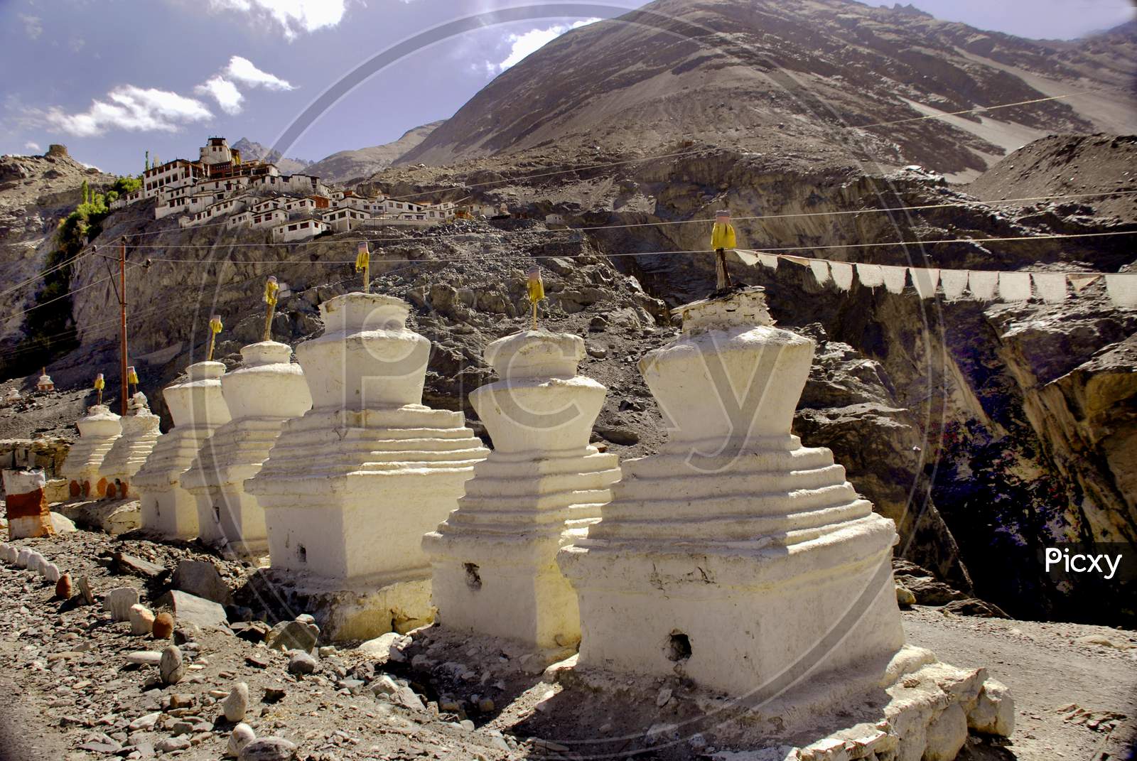 Shanthi Stupas At Thiksey Monastery With Mountains In Background