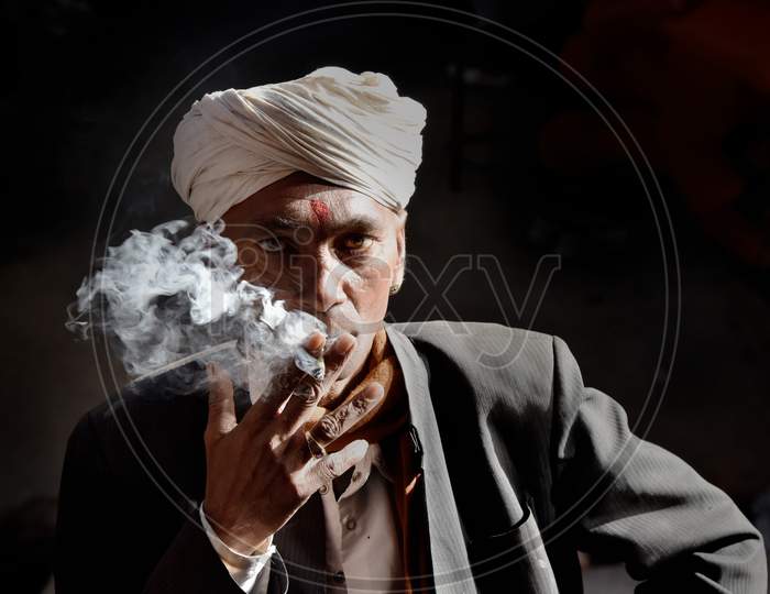 Portrait Of An Indian Man Smoking