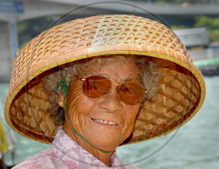 A Thailand Woman Wearing a Wooden Weaved Cap