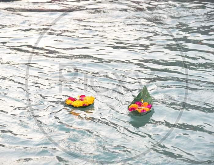 Pilgrims For Performing Pooja to Holy River Ganga and Leaving Flowers in Ganga Water
