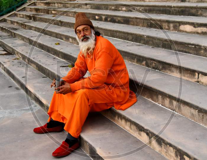 Indian Sadhu Or Baba Sitting At a River Bank