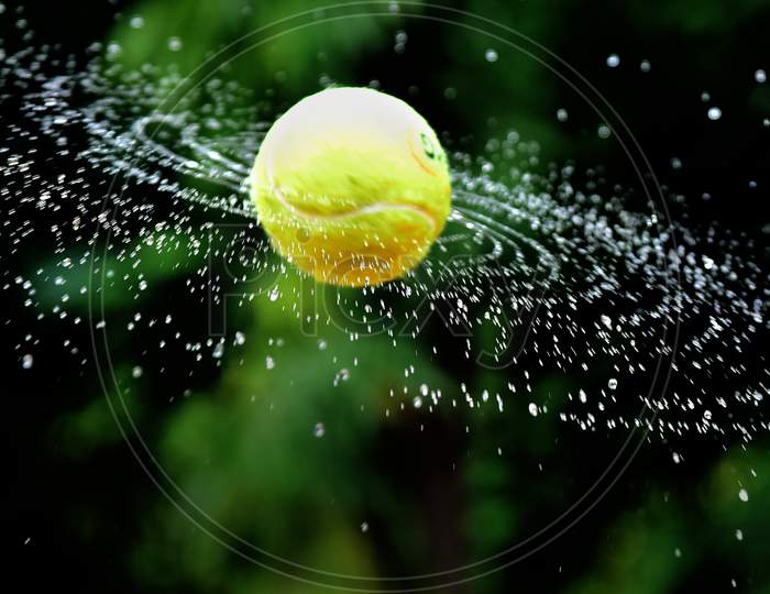 Spinning Tennis Ball With Water Droplet Pattern