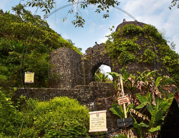 A View Of Sinhagad Fort Entrance With Green Decaying Plants in Maharashtra , India