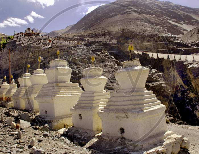 Shanthi Stupas At Thiksey Monastery With Mountains In Background
