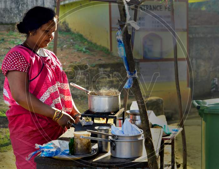 A Woman Making Tea A Road Side Tea Vendor Stall In India