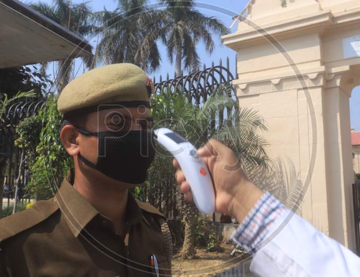 A Doctor Checking CISF Security Personnel With Thermal Scanner For Corona Or COVID 19