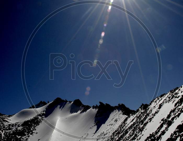 Bright Sun Over A Snow Filled Mountain In Ladakh