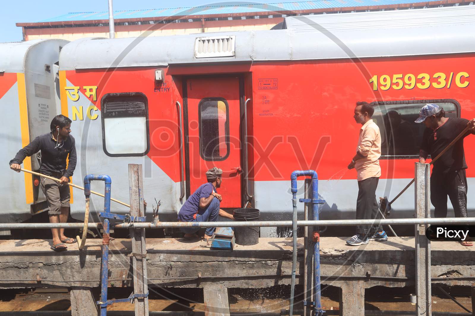 Indian Railways Sanitary Workers Cleaning Trains At a Railway Station platform Due To Corona Virus Or COVID 19 Outbreak In India