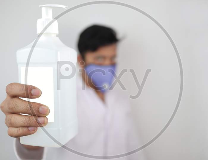 A Male Doctor Holding A Bottle Of Hand Sanitizer With Selective Focus Hand Sanitizer Bottle.Clean Your Hands For Corona Virus Concept Image.