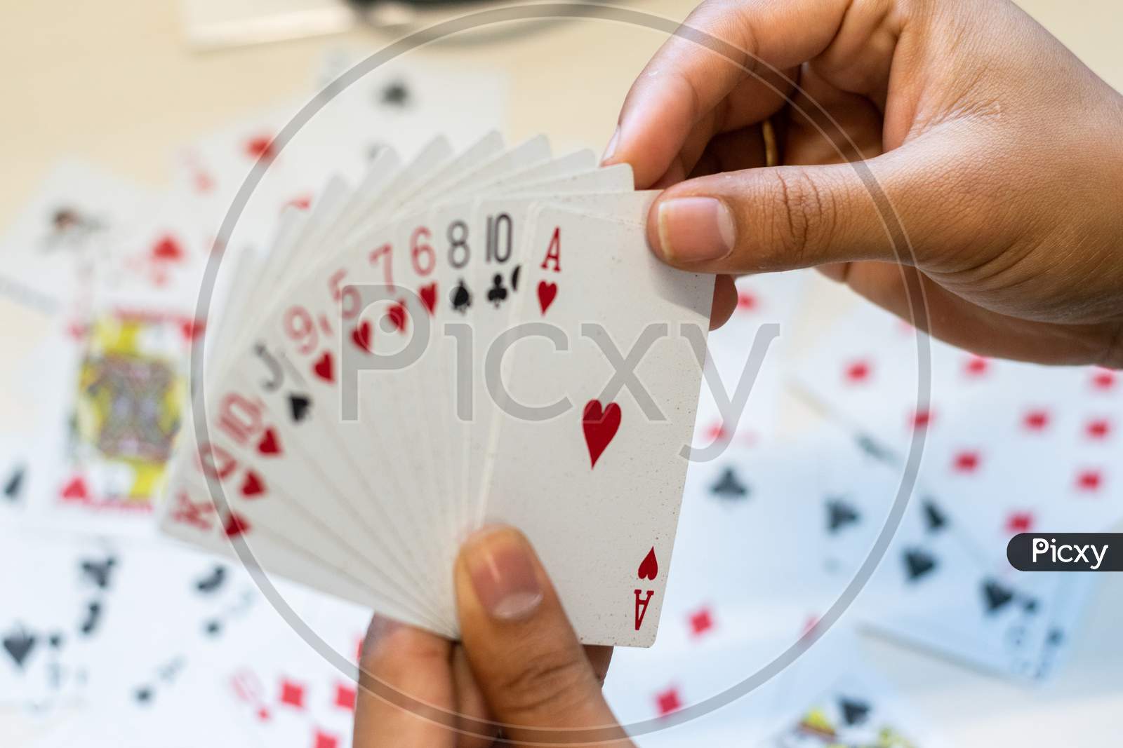 hand holding playing cards during a game