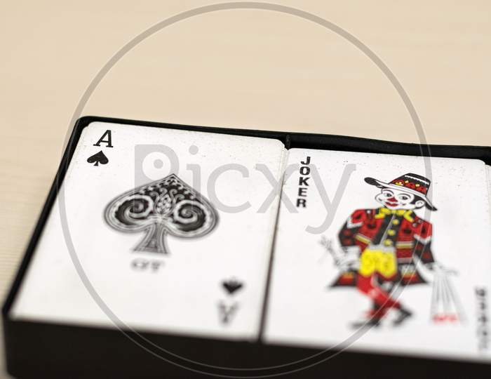 Ace of spades and joker playing card in a box