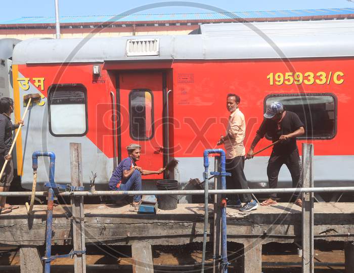 Indian Railways Sanitary Workers Cleaning Trains At a Railway Station platform Due To Corona Virus Or COVID 19 Outbreak In India