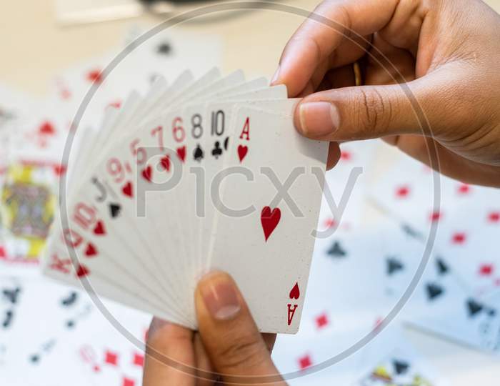 hand holding playing cards during a game