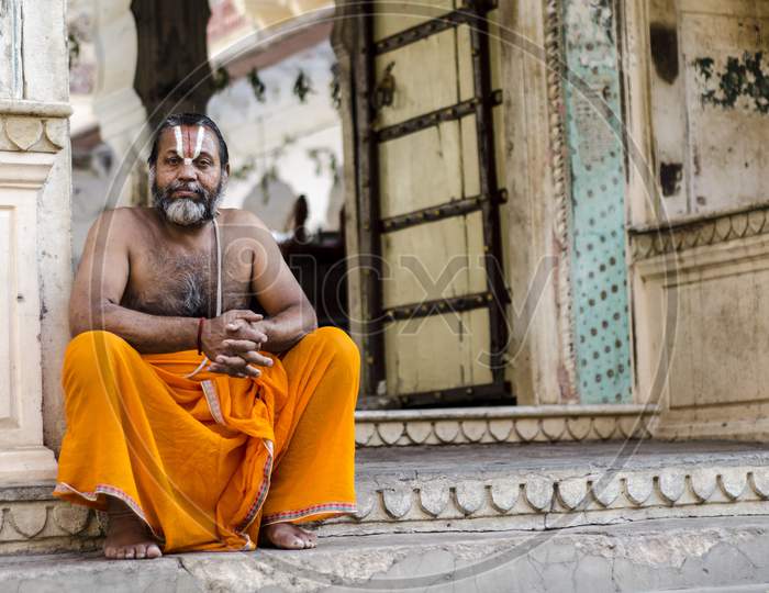 Priest sitting outside a temple