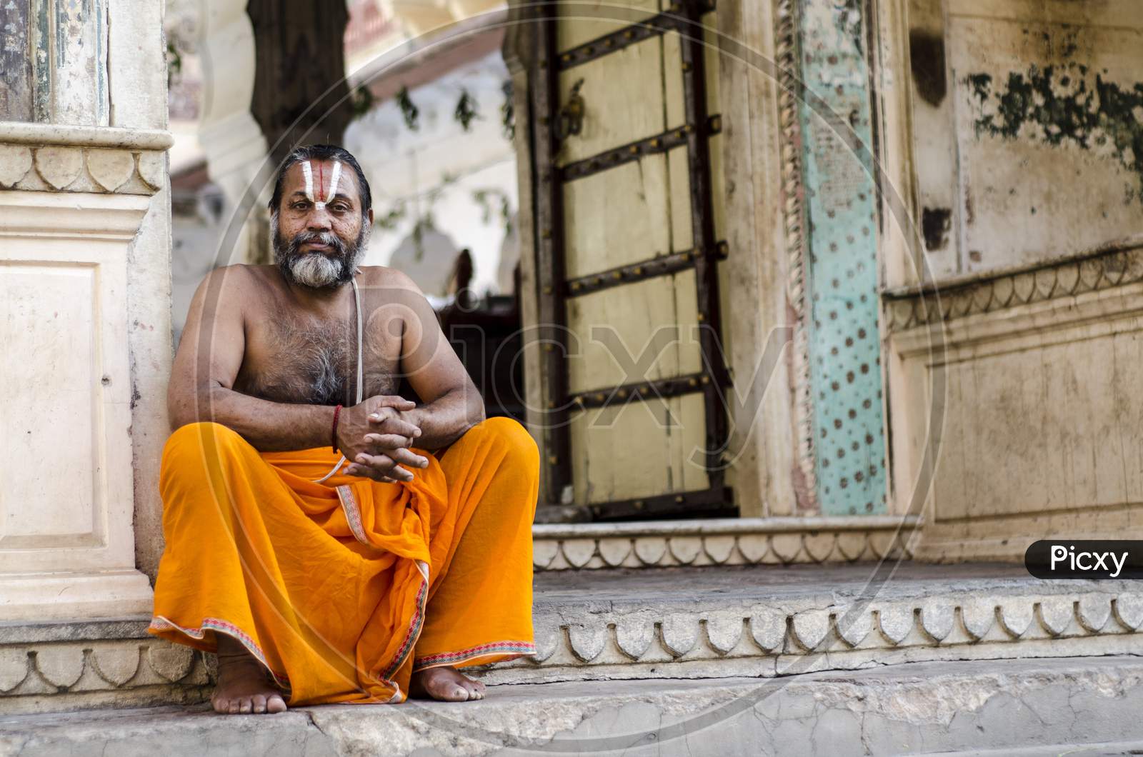 Priest sitting outside a temple