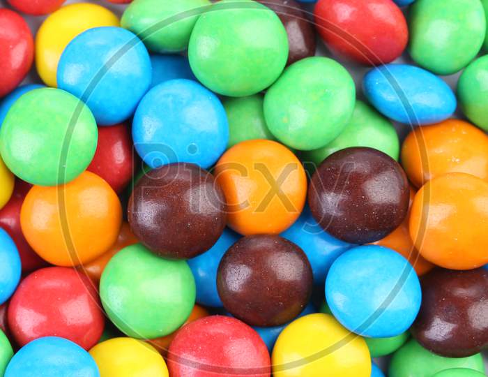 Chocolate Balls In Colorful Glaze. Whole Background.