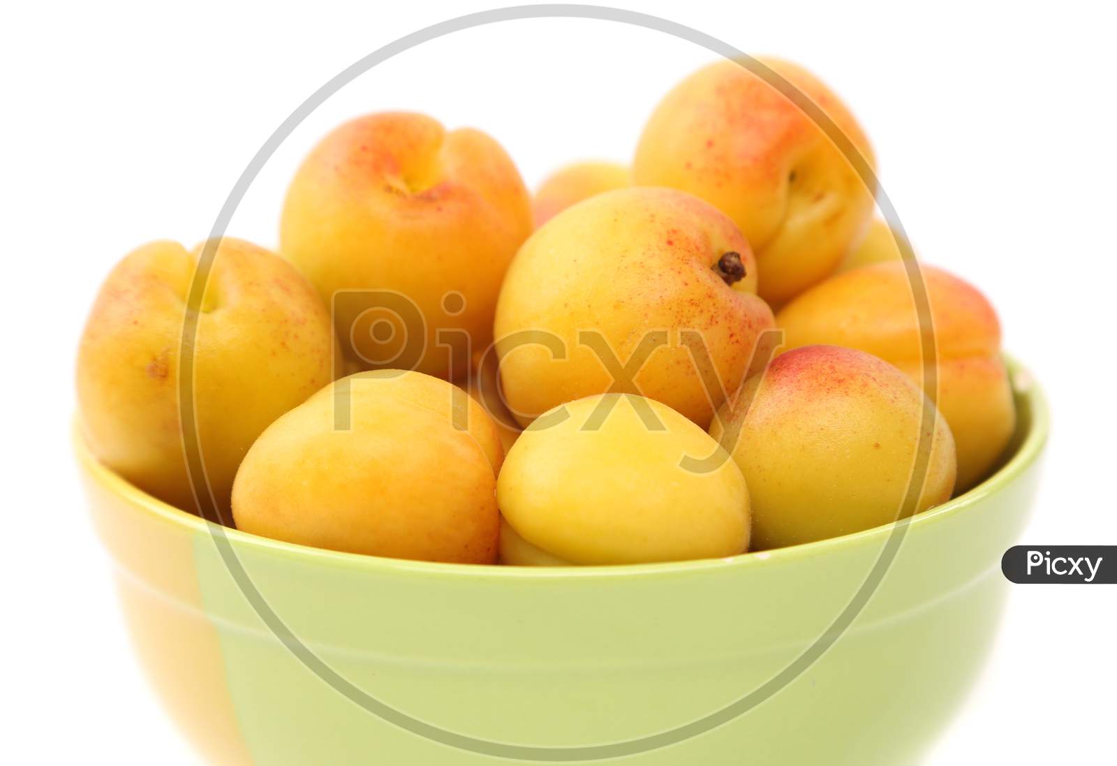Apricots In A Deep Plate. Isolated On A White Background.