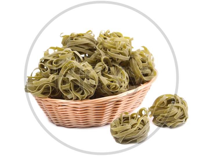 Italian Pasta Tagliatelle In Basket. Isolated On A White Background.