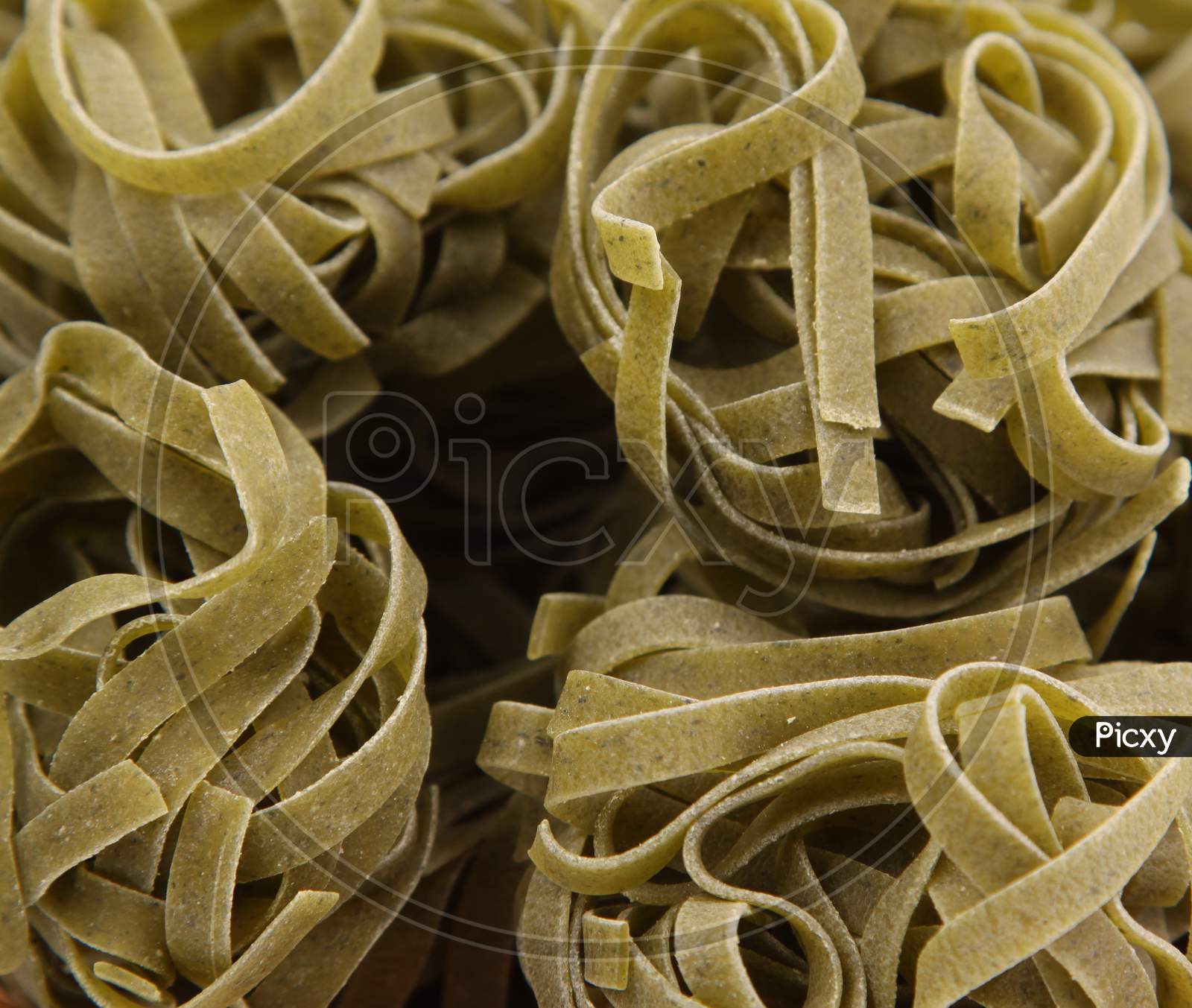 Italian Green Pasta Tagliatelle. Close Up. Whole Background.