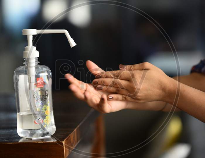 A woman scrubbing her hands after using the Hand Sanitizer to prevent the infection from novel viruses