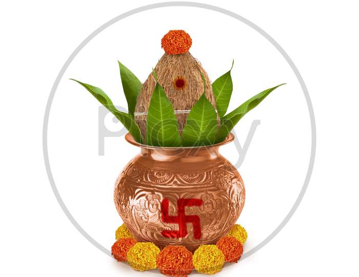 Copper and gold kalash with coconut and mango leaf with marigold flower decoration at the bottom for hindu puja for all hindu pooja occasions