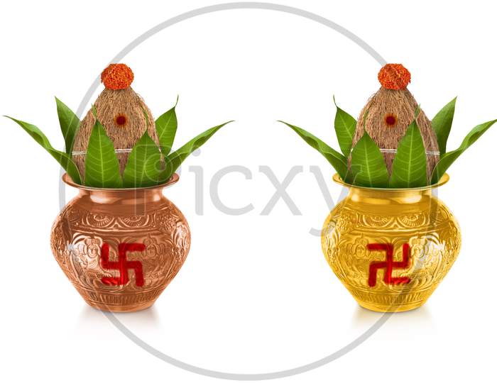Copper and gold kalash with coconut and mango leaf with marigold flower decoration at the bottom for hindu puja for all hindu pooja occasions