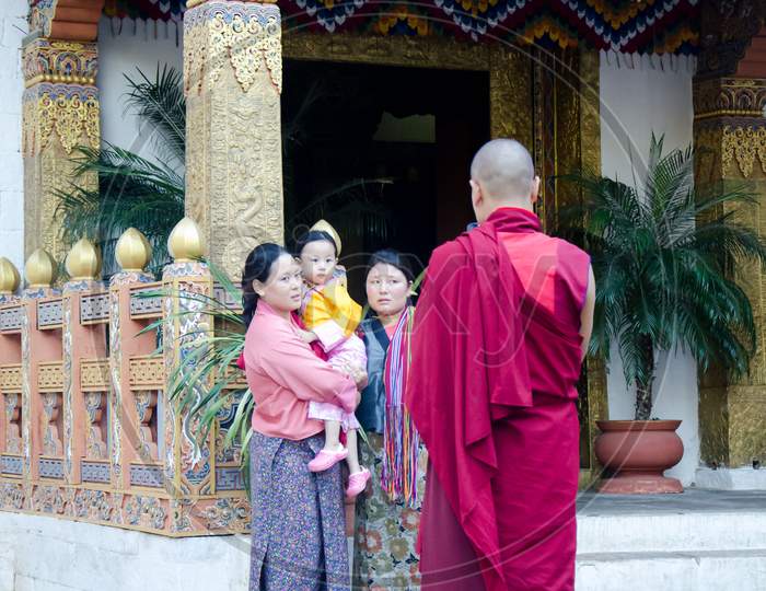 Monk clicking a picture of family