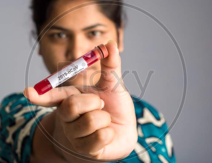 Woman Holding A Test Tube With Blood Sample For Coronavirus Or 2019-Ncov Analyzing.