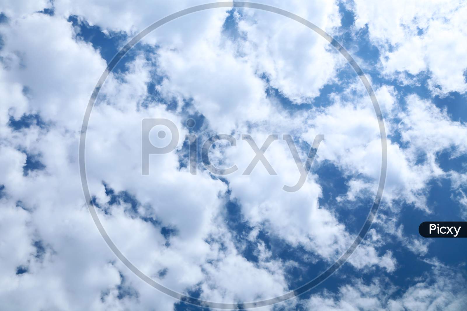 Fluffy Clouds On The Blue Sky. Whole Background.