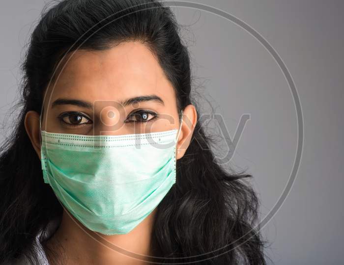 Closeup Portrait Of A Young Girl Or Woman Doctor Wearing A Medical Or Surgical Mask