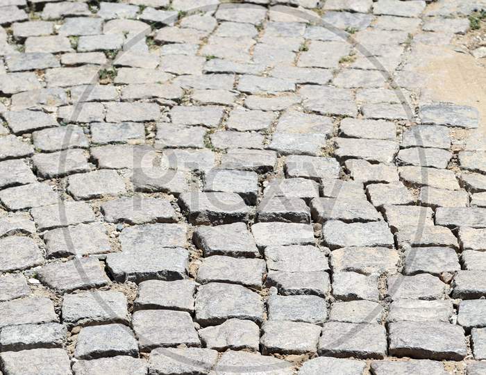 Stone Road Texture. Cobblestones. Closeup. Whole Background.