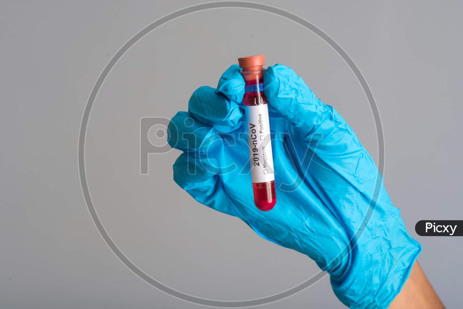 Woman Doctor Holding A Test Tube With Blood Sample For Coronavirus Or 2019-Ncov Analyzing.