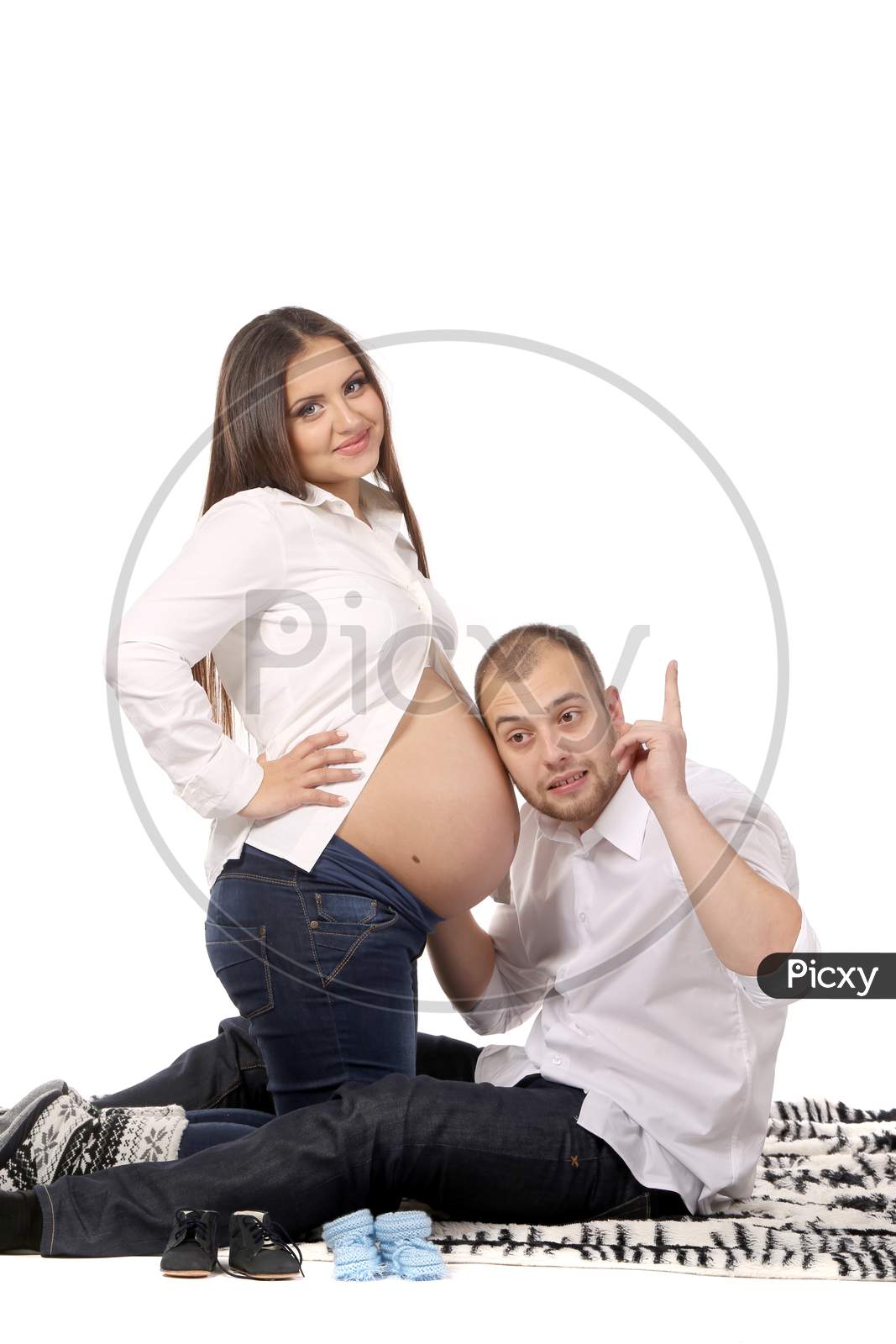 Young Couple Expecting Baby. Isolated On A White Background.