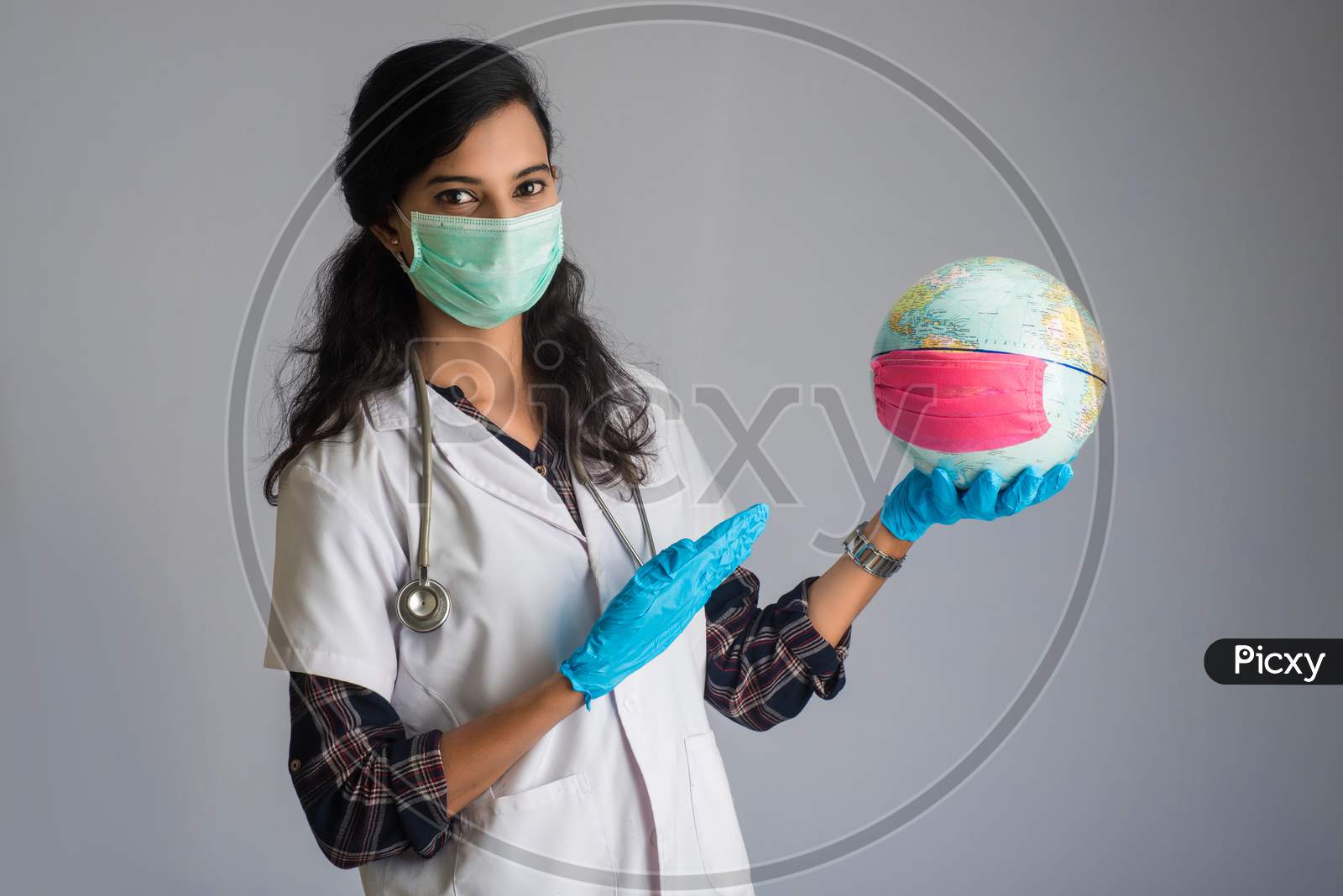 Woman Doctor Holding World Globe With A Medicine Face Mask. World Epidemic Of Coronavirus Concept.