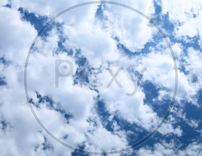Fluffy Clouds On The Blue Sky. Whole Background.