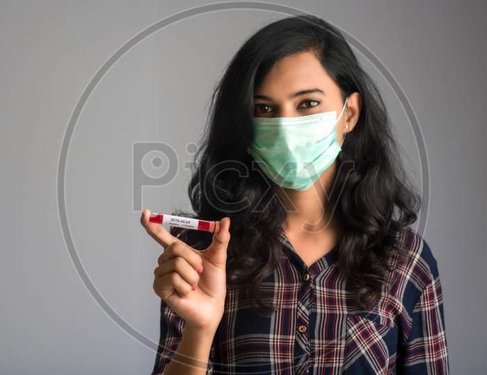 Woman Holding A Test Tube With Blood Sample For Coronavirus Or 2019-Ncov Analyzing.