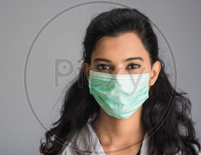 Closeup Portrait Of A Young Girl Or Woman Doctor Wearing A Medical Or Surgical Mask