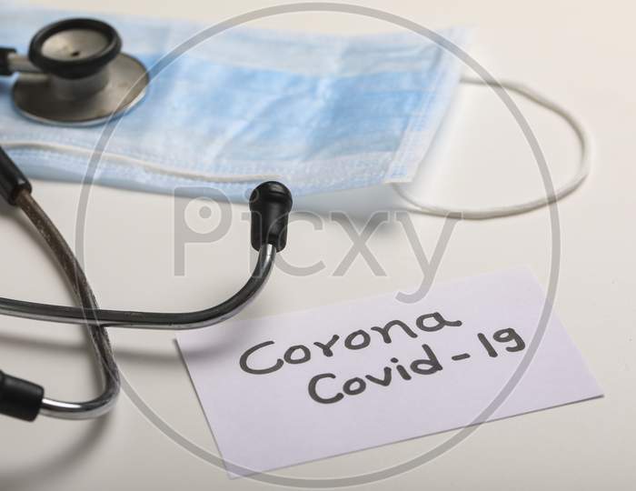 Anti Viral Surgical mask For Safety of COVID 19 or Corona Virus With Stethoscope Over a White Background