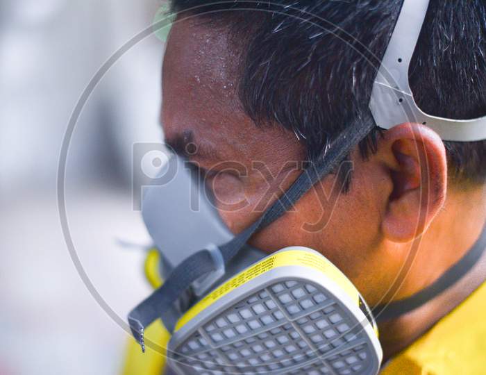 Disaster Response Force(DRF) man sweating heavily after spraying Disinfectant Solution across the Hyderabad City to reduce the spread of the COVID-19 Virus or Coronavirus at Ameerpet Metro Station