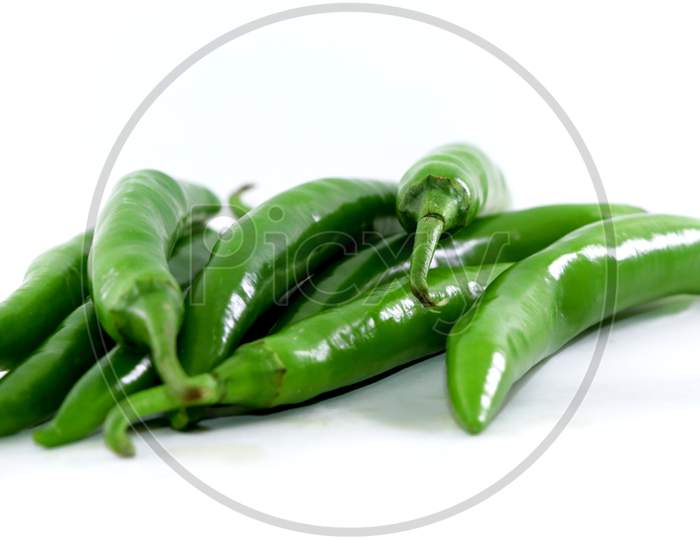 Bunch Of Fresh Green Chili Peppers On A White Background