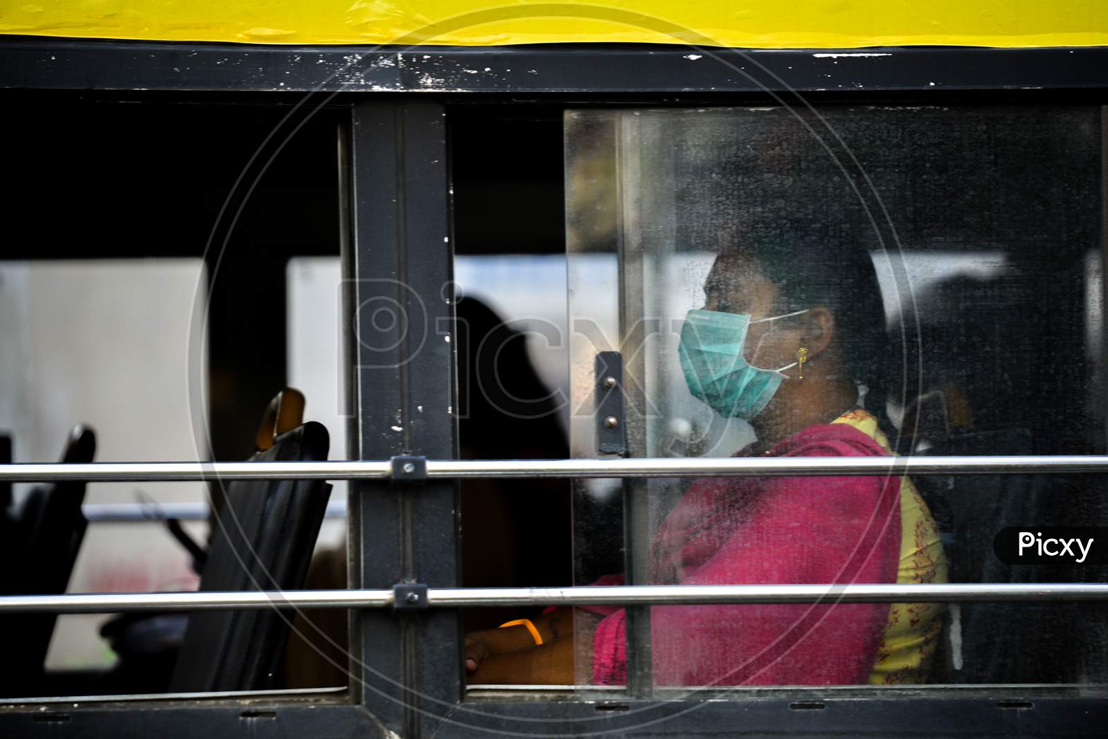 A women wearing a protective face mask as she travels in a tsrtc city bus in the wake of Coronavirus outbreak in Hyderabad