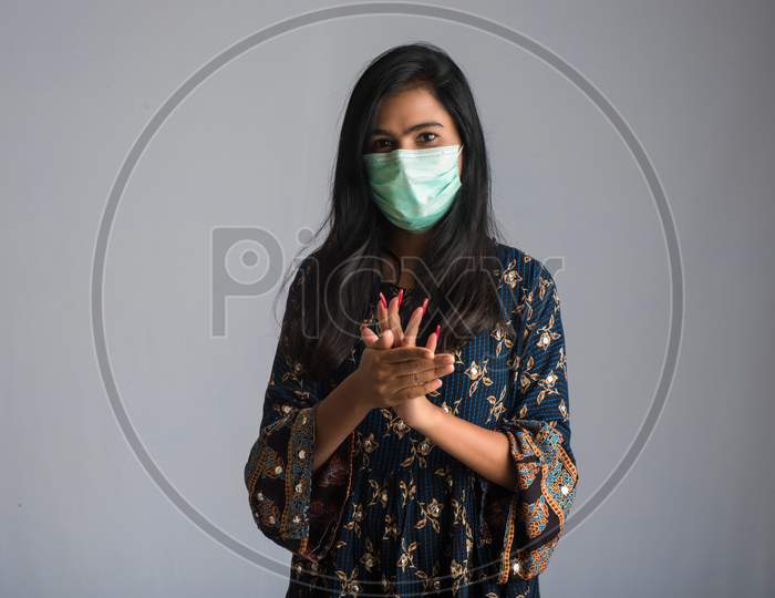 Portrait Of Young Girl Using Or Showing A Sanitizing Gel From A Bottle For Hands Cleaning.