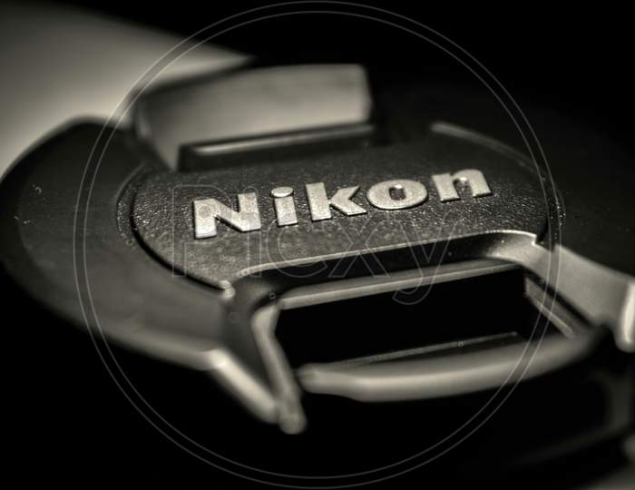 A closup picture of nikon camera lens cap.