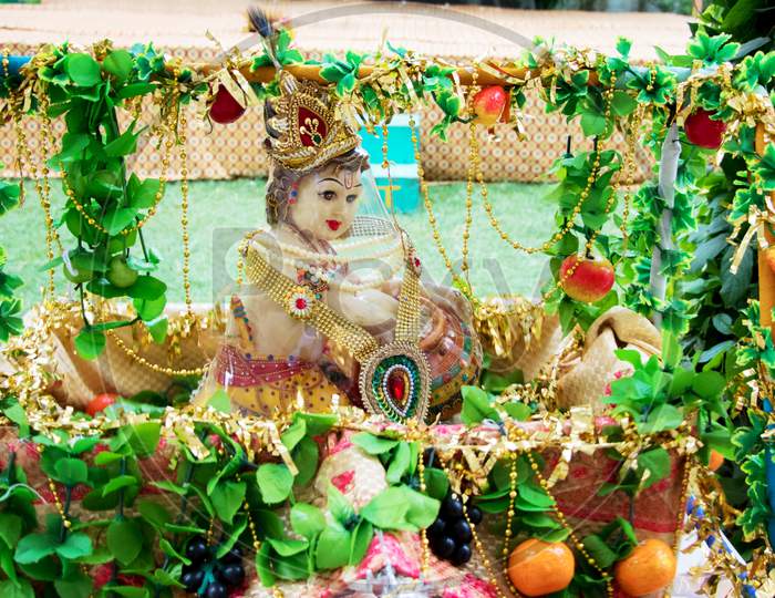 The Hindu God, Lord Krishna, In His Childhood Form, Eating Butter